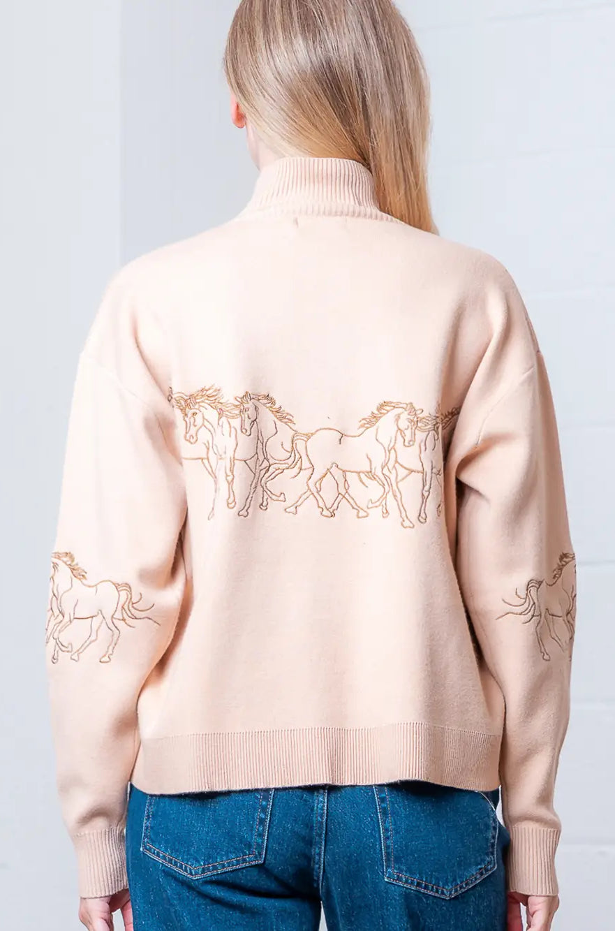 Back view of taupe quarter-zip sweater showing relaxed drape and rib hem
