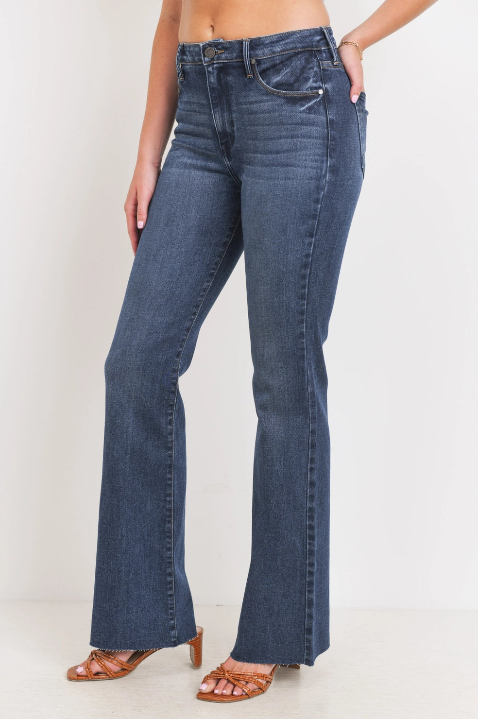 Person wearing blue jeans on a plain background