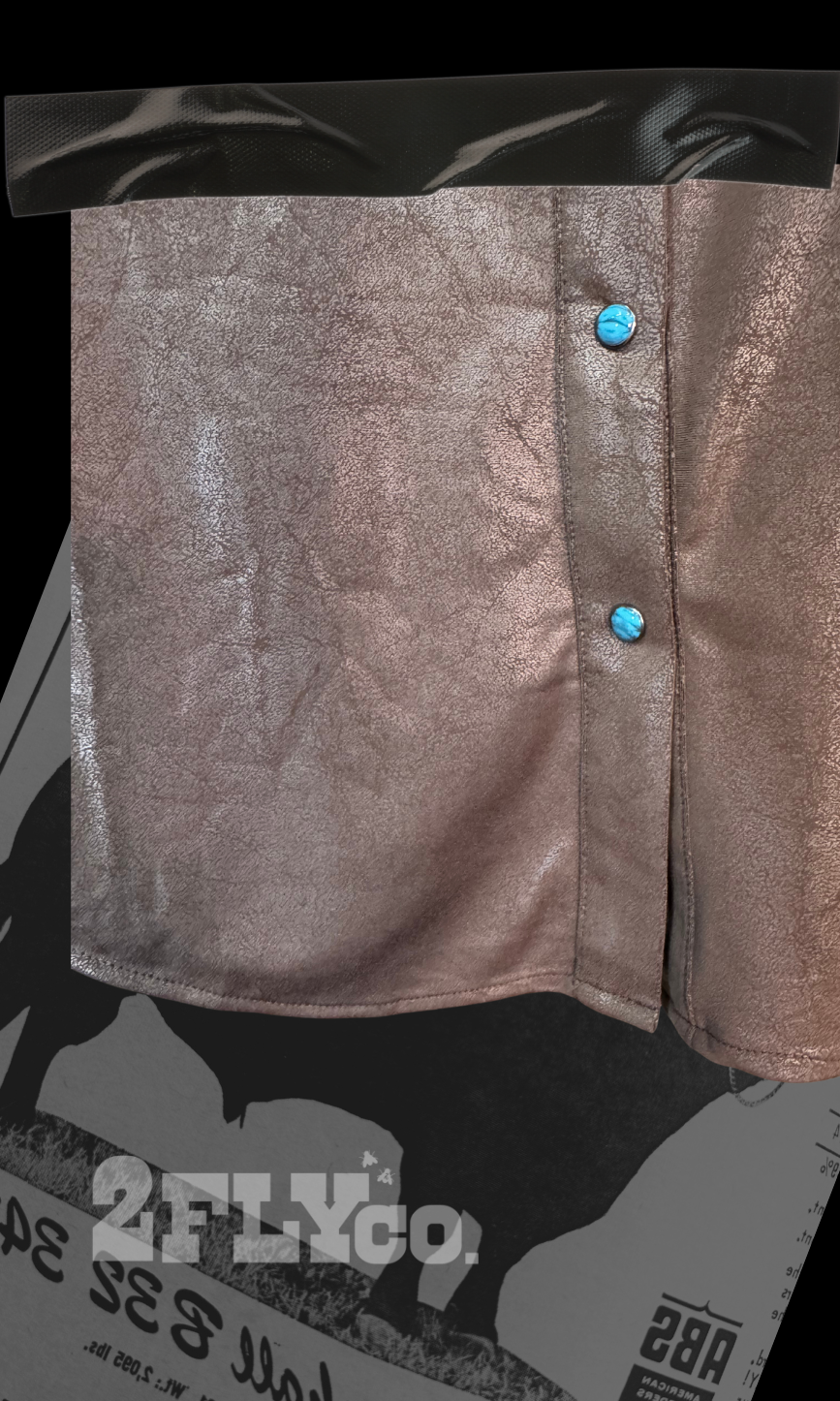 Metallic blouse with turquoise blue buttons on a black and white background