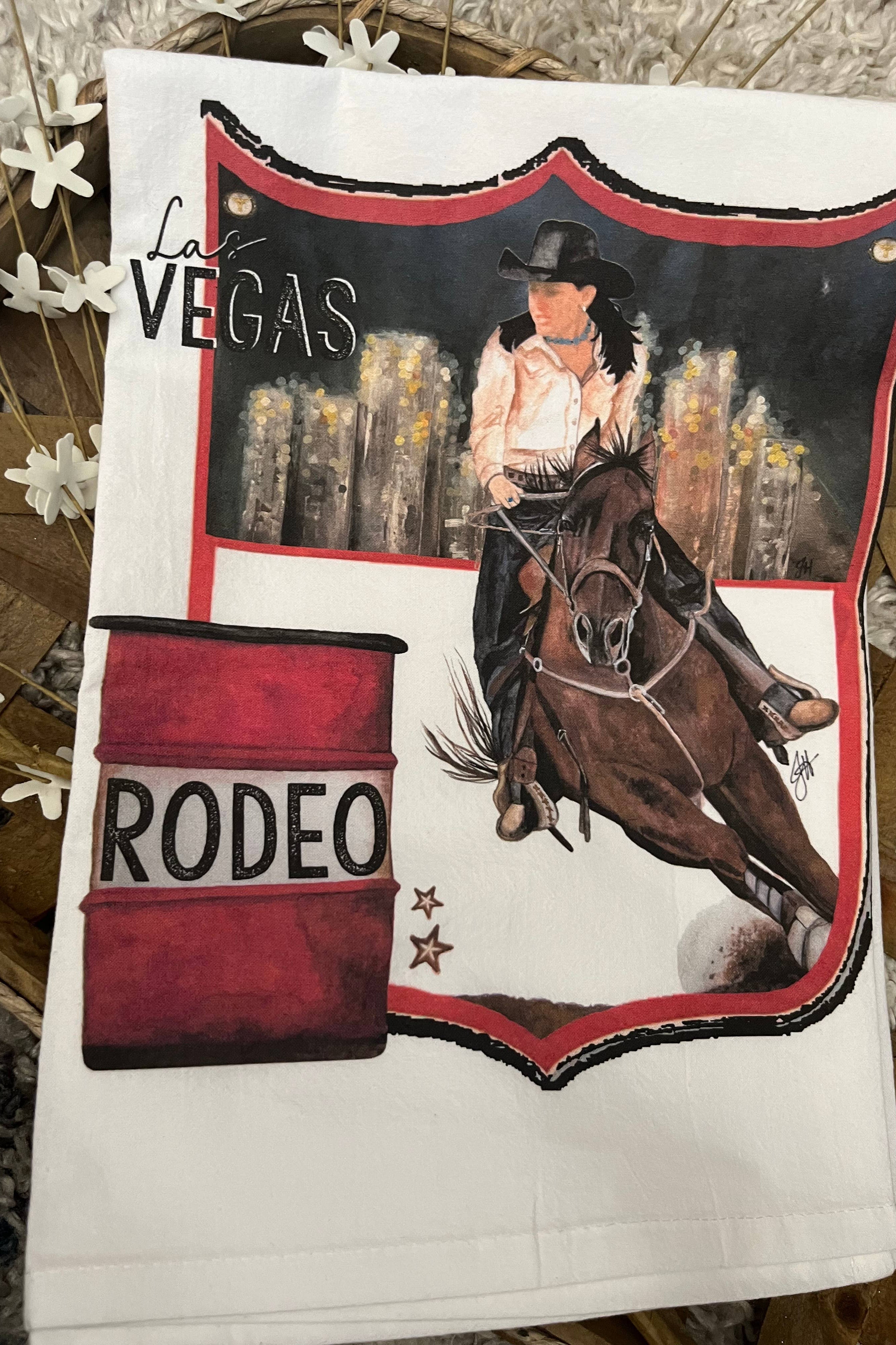 Tea towel with a rodeo design featuring a cowgirl on a horse and a barrel, with 'Las Vegas Rodeo' text.