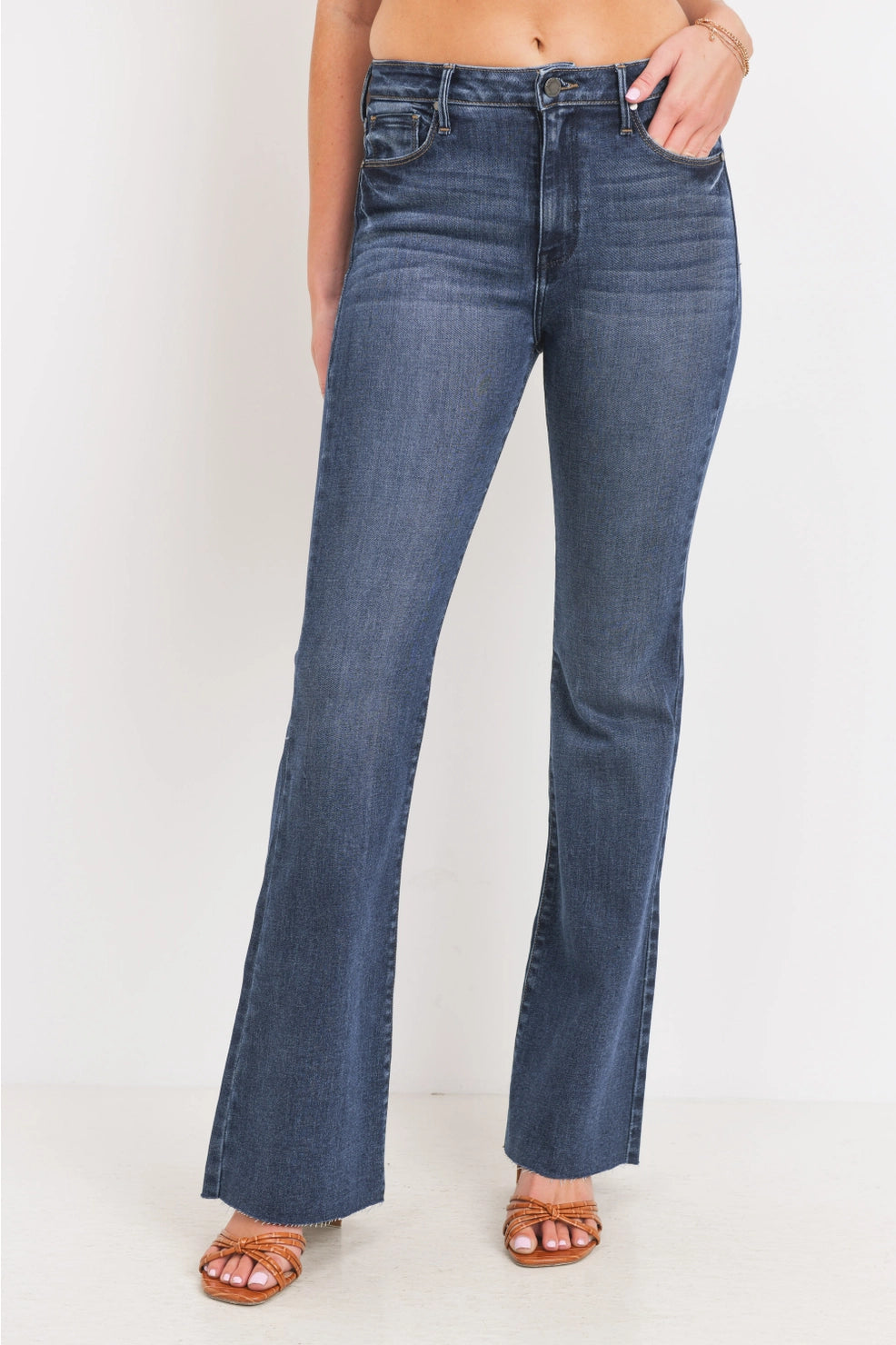 Person wearing blue jeans on a white background