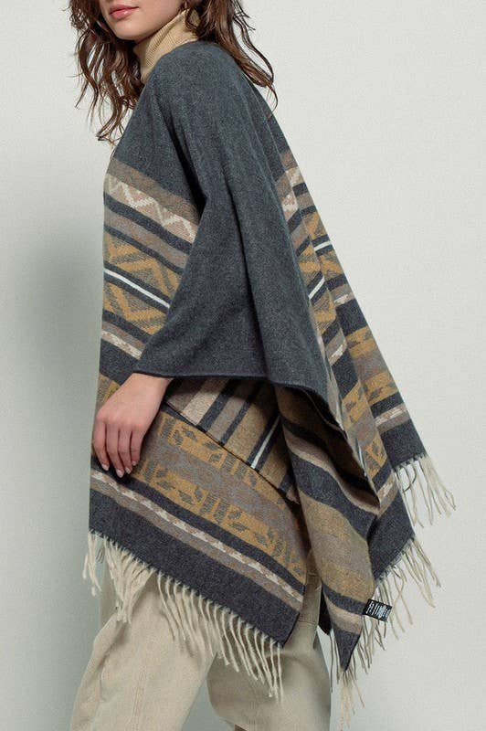 Dark gray poncho with brown and beige striped pattern and fringes on a white background