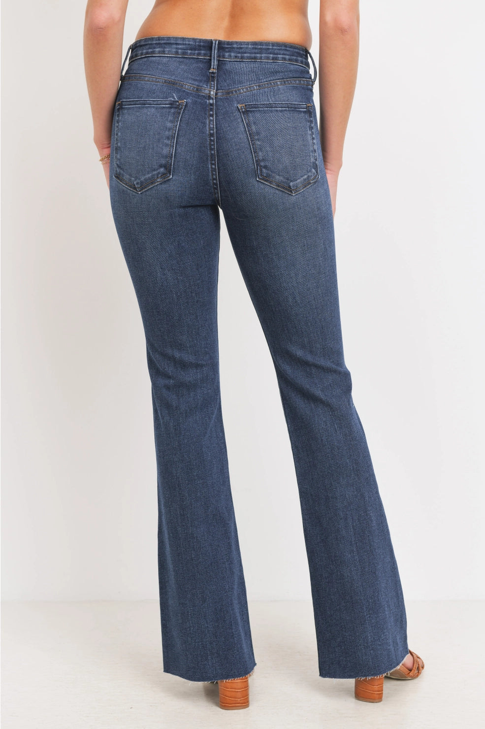 Blue jeans worn by a person on a white background
