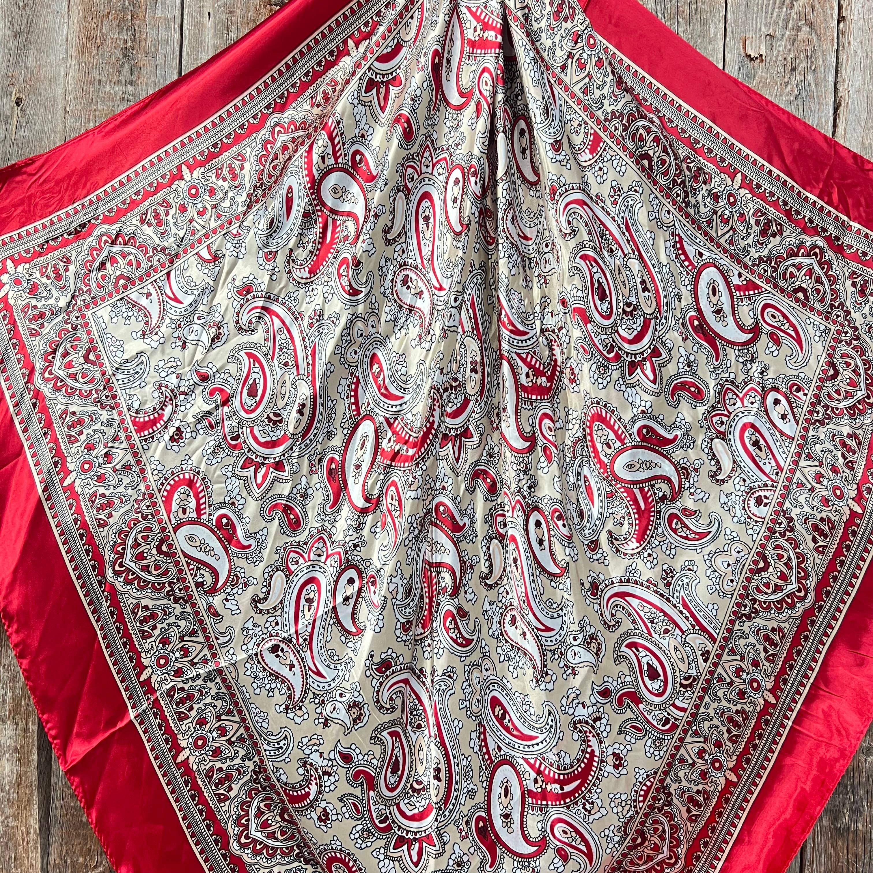 Red and white paisley patterned fabric on a wooden surface