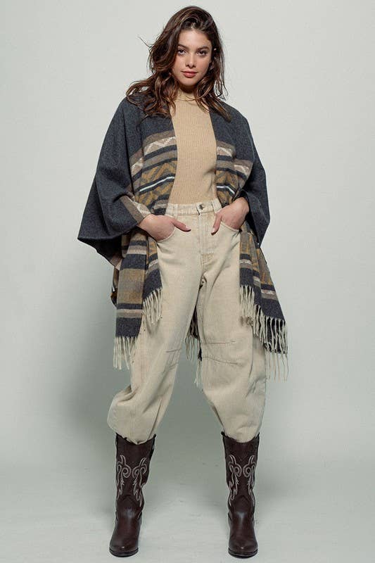 Dark gray poncho with brown and beige striped pattern and fringes on a white background