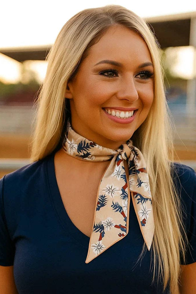 Woman wearing a patterned scarf around her neck with a blurred background