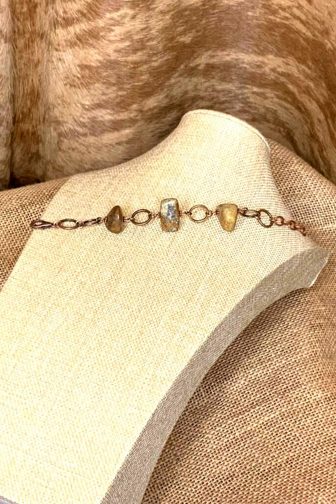 Handcrafted stone bracelet featuring polished natural brown and beige stones with copper links and lobster clasp
