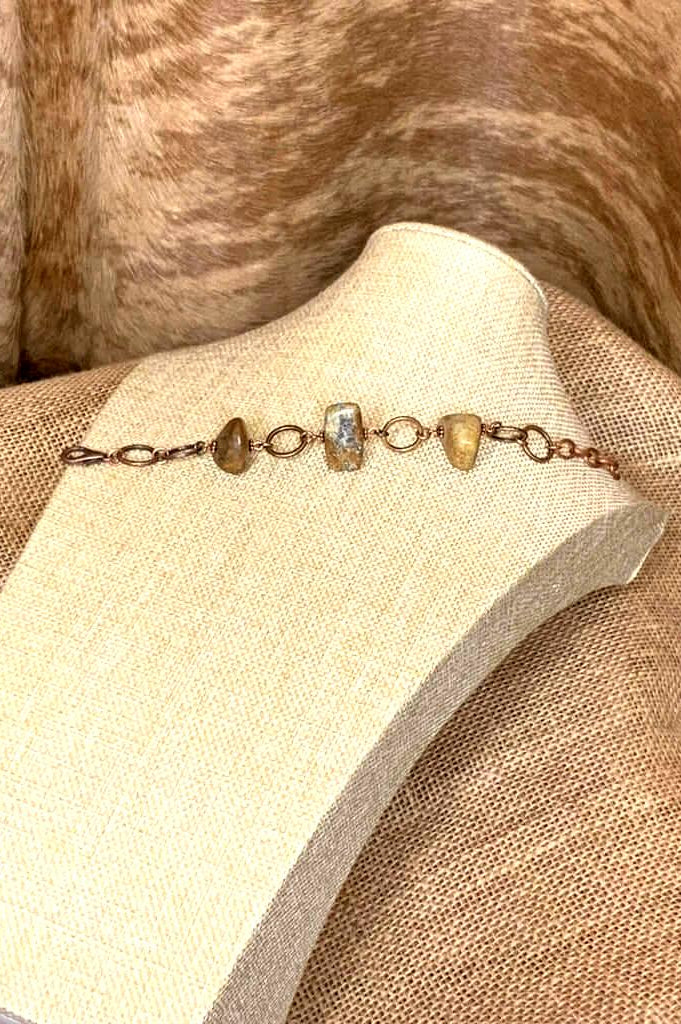 Handcrafted stone bracelet featuring polished natural brown and beige stones with copper links and lobster clasp