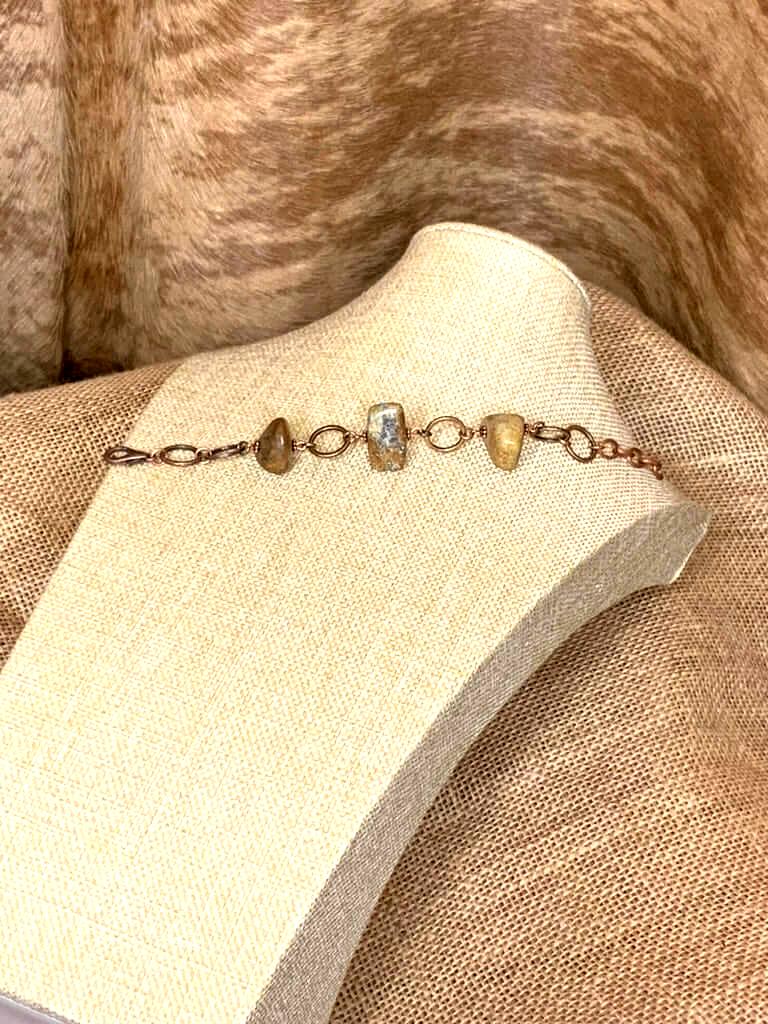 Handcrafted stone bracelet featuring polished natural brown and beige stones with copper links and lobster clasp