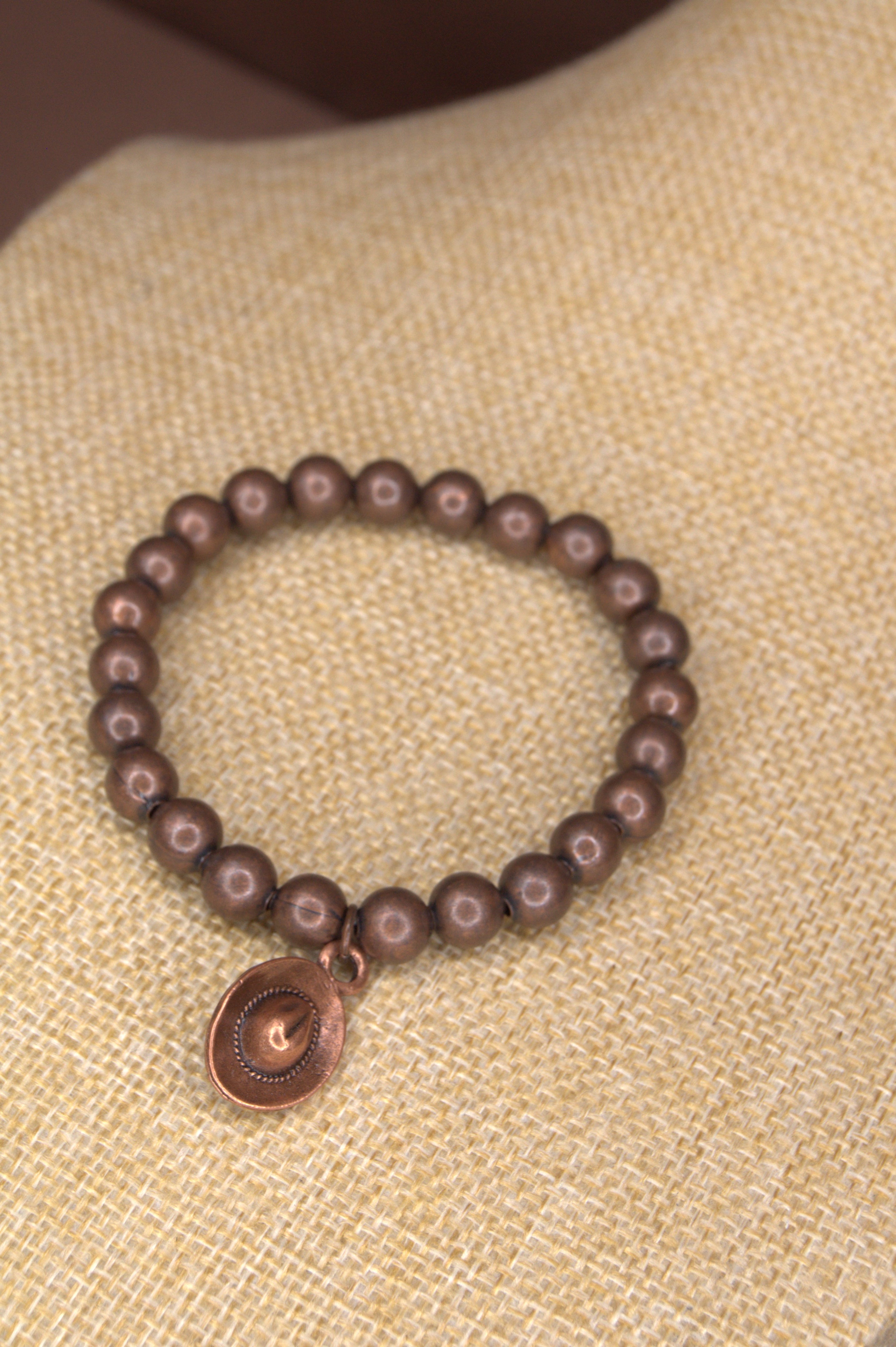 Copper 8mm metal beaded bracelet woth a small copper cowboy hat charm