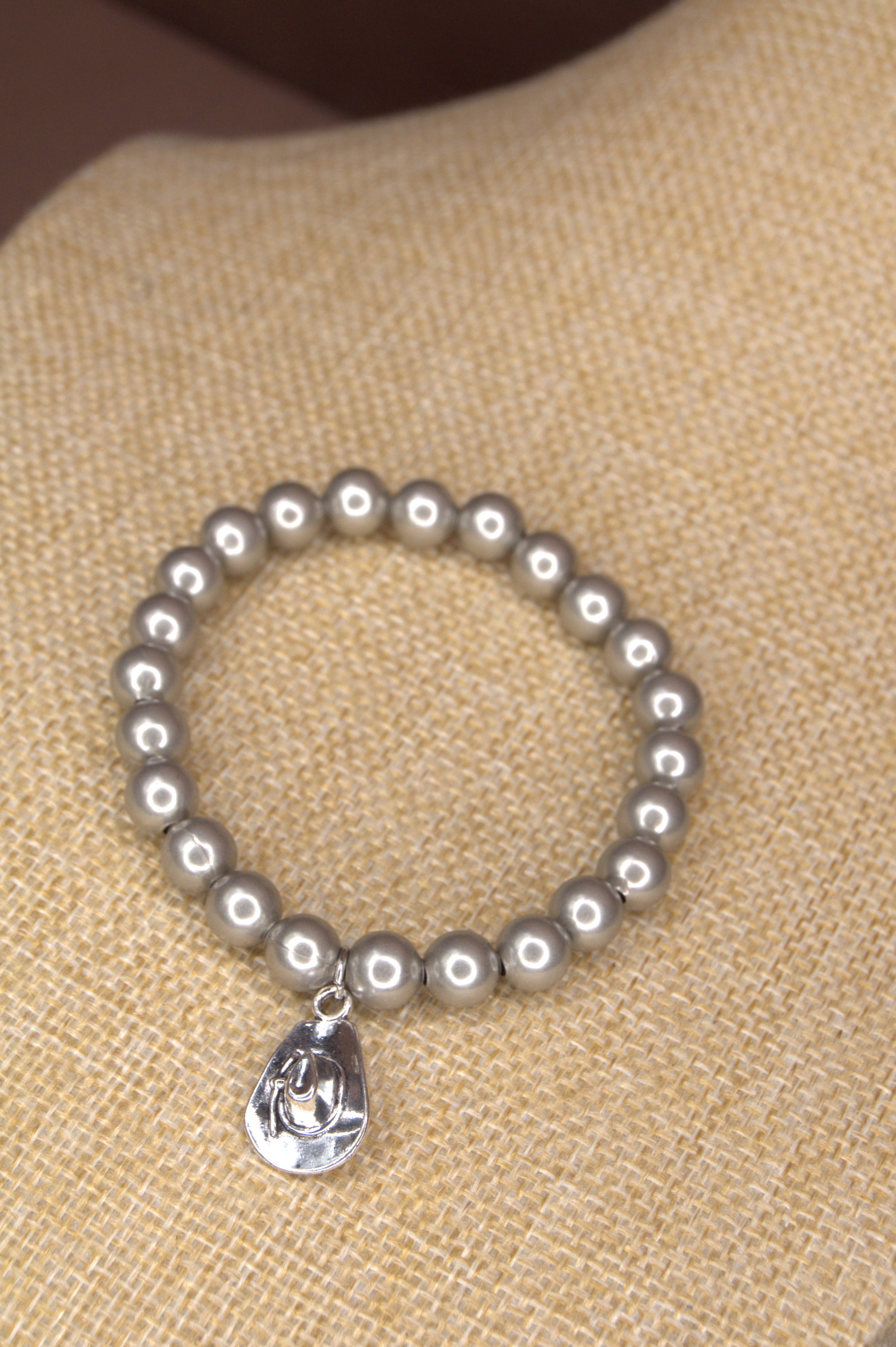 Antique Silver platted 8mm metal beaded bracelet with a small silver cowboy hat charm