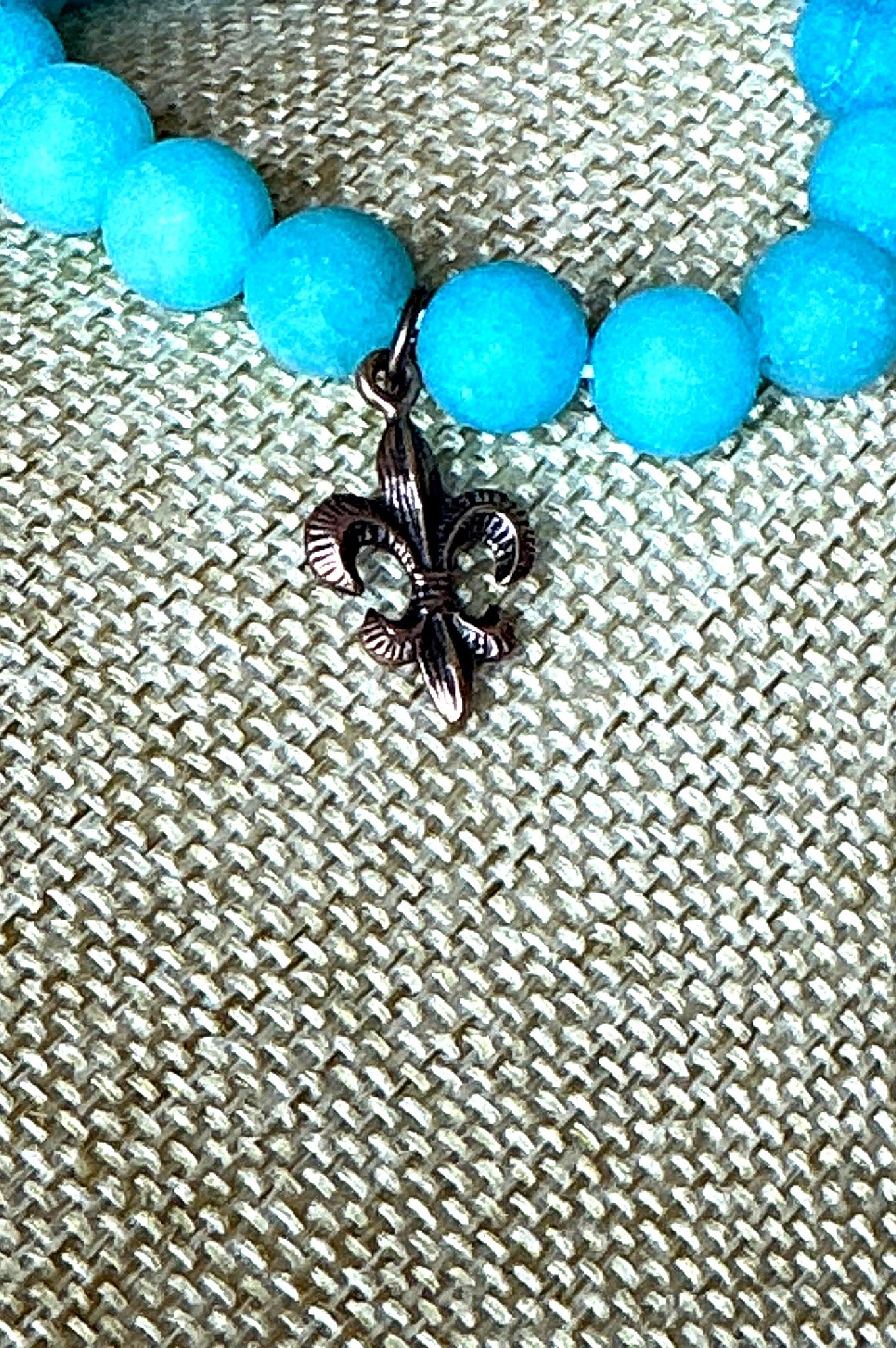 Handcrafted turquoise bead stretch bracelet with copper fleur-de-lis charm