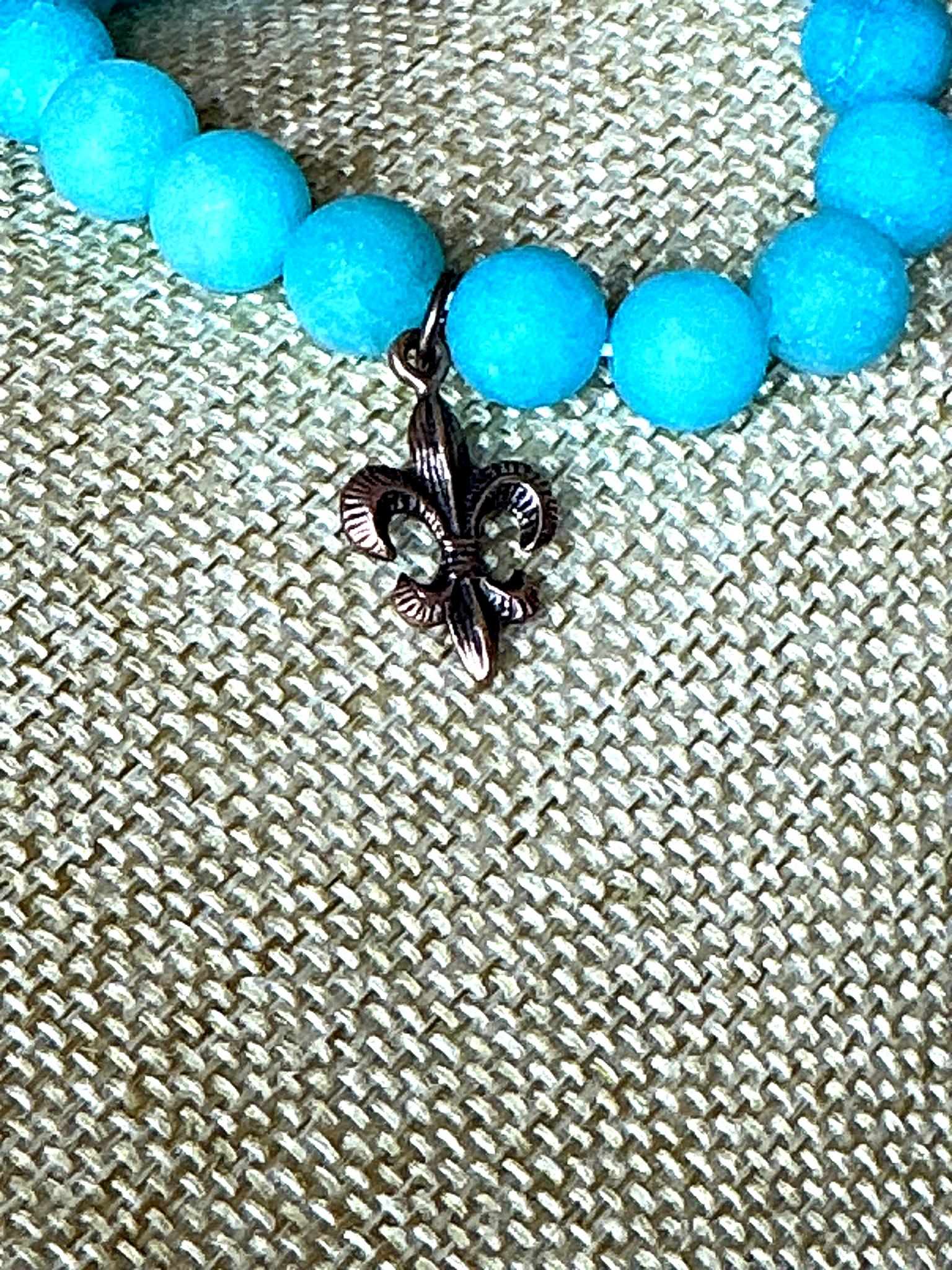 Handcrafted turquoise bead stretch bracelet with copper fleur-de-lis charm