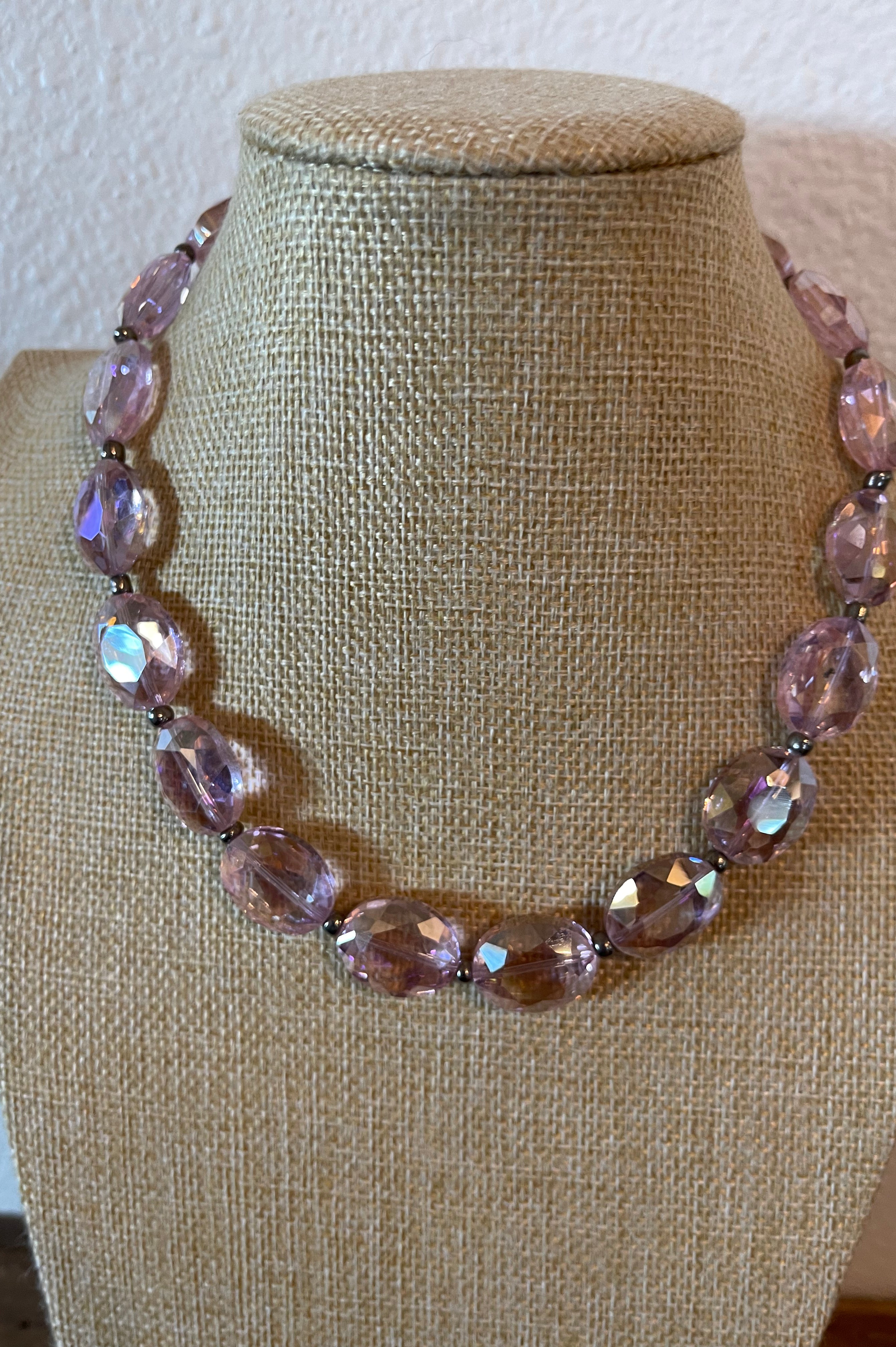 Pink crystal necklace with silver seed beads in between the crystals.