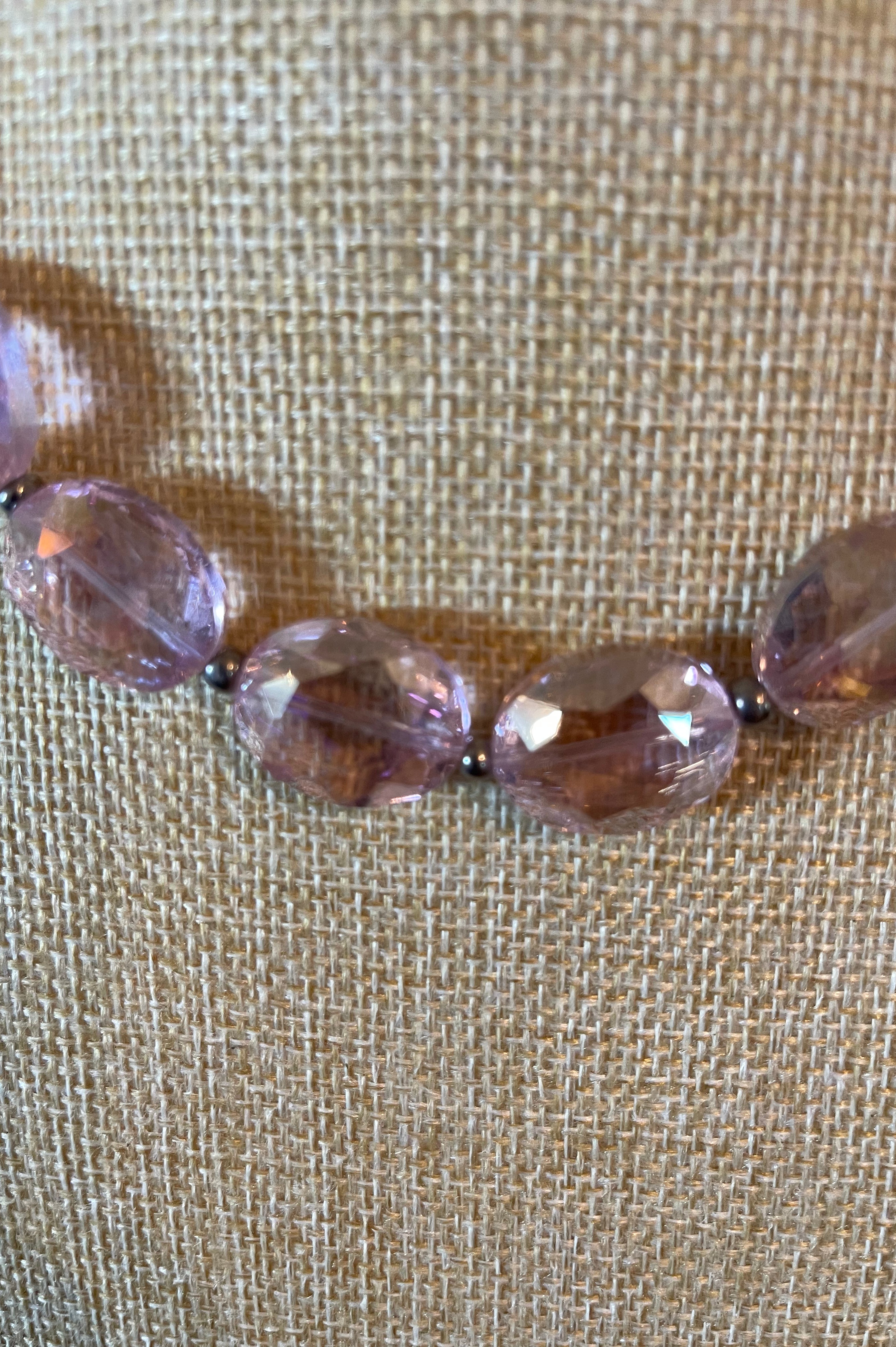 Pink crystal necklace with silver seed beads in between the crystals.