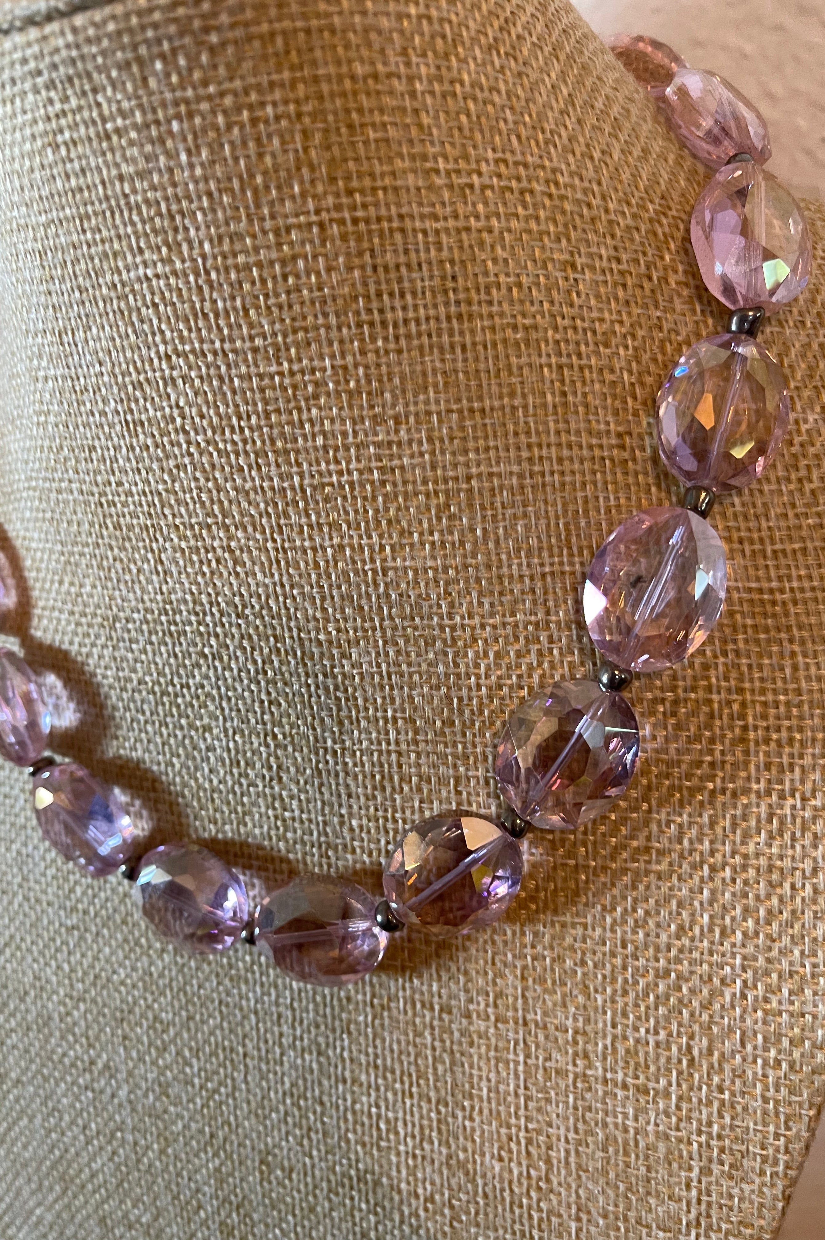Pink crystal necklace with silver seed beads in between the crystals.