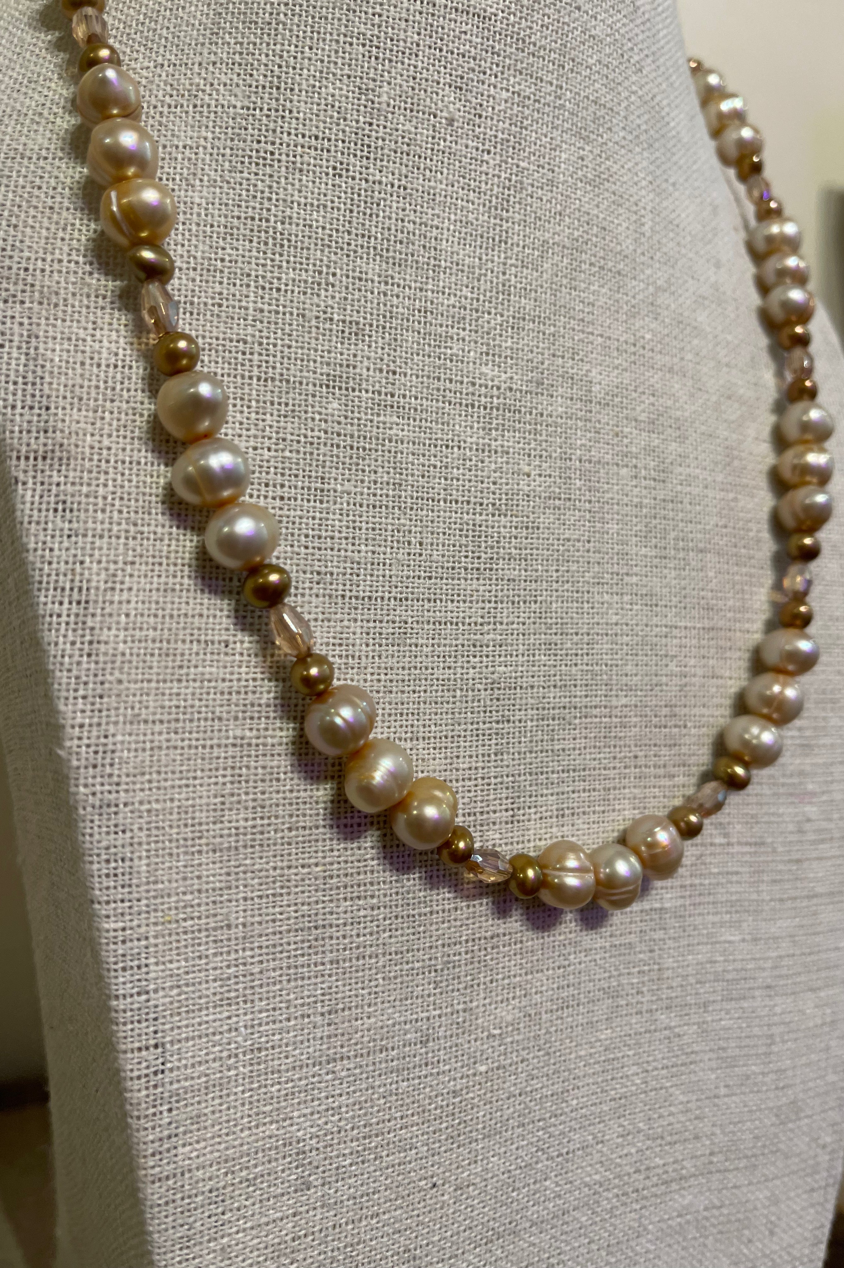 Pearl necklace on a gray mannequin bust