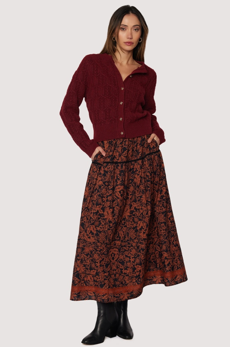front view long skirt rust floral pattern over black background