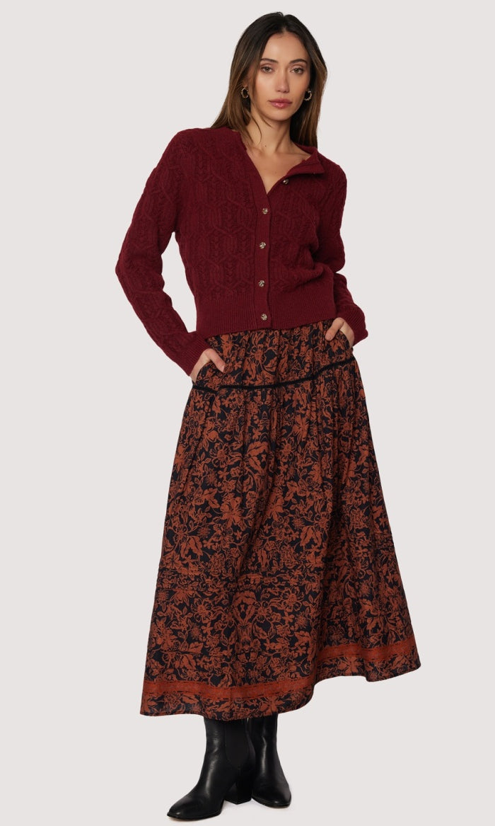 front view long skirt rust floral pattern over black background