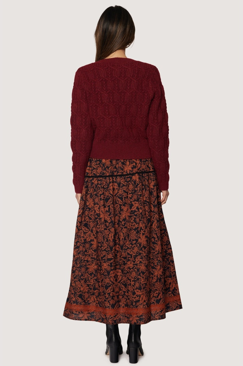 back view long skirt rust floral pattern over black background
