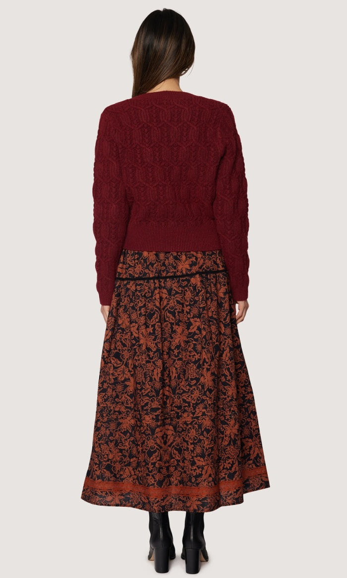back view long skirt rust floral pattern over black background