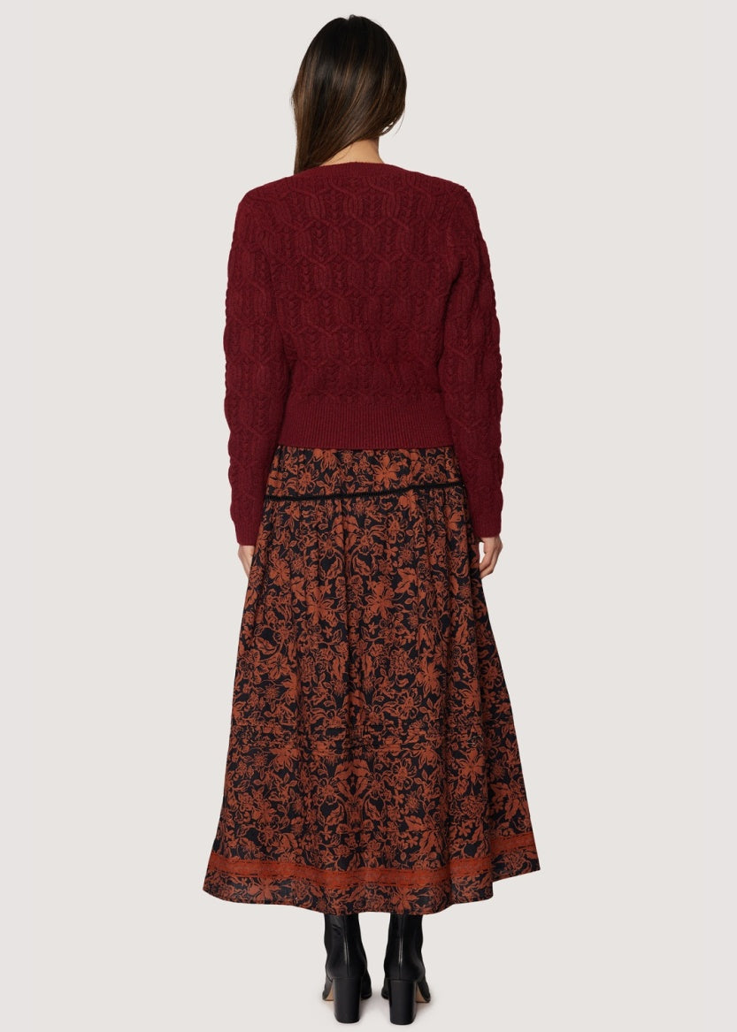 back view long skirt rust floral pattern over black background