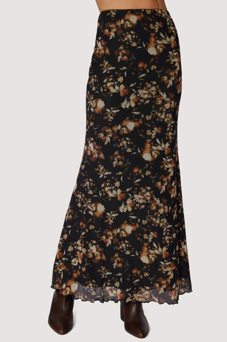 Long skirt black back ground with floral. earth tone pattern in rust , tan and gold