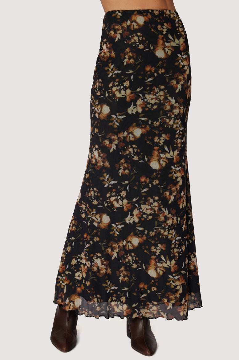 Long skirt black back ground with floral. earth tone pattern in rust , tan and gold