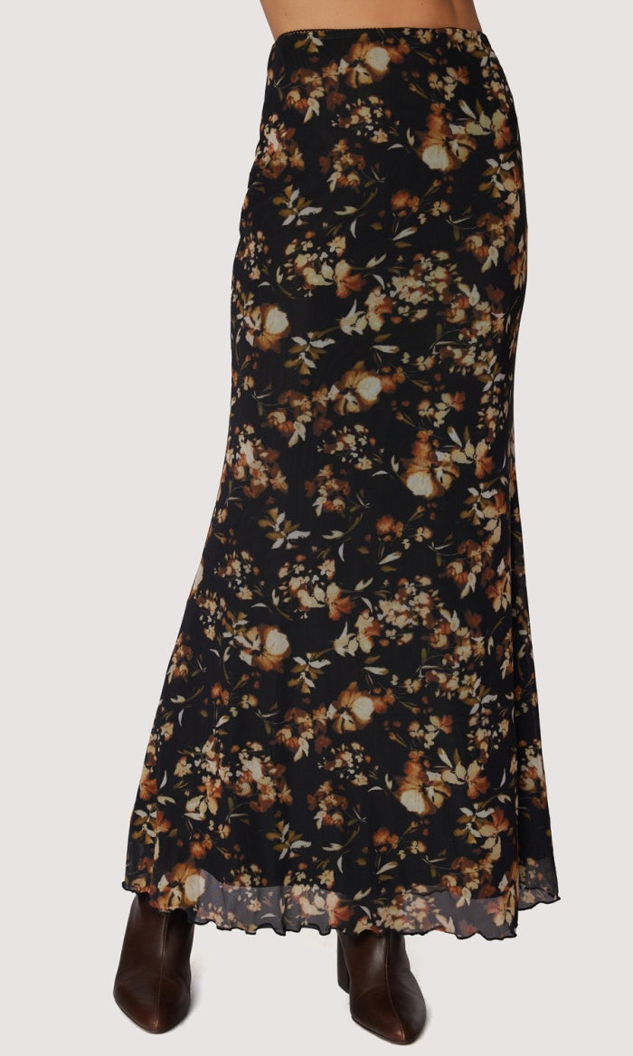 Long skirt black back ground with floral. earth tone pattern in rust , tan and gold