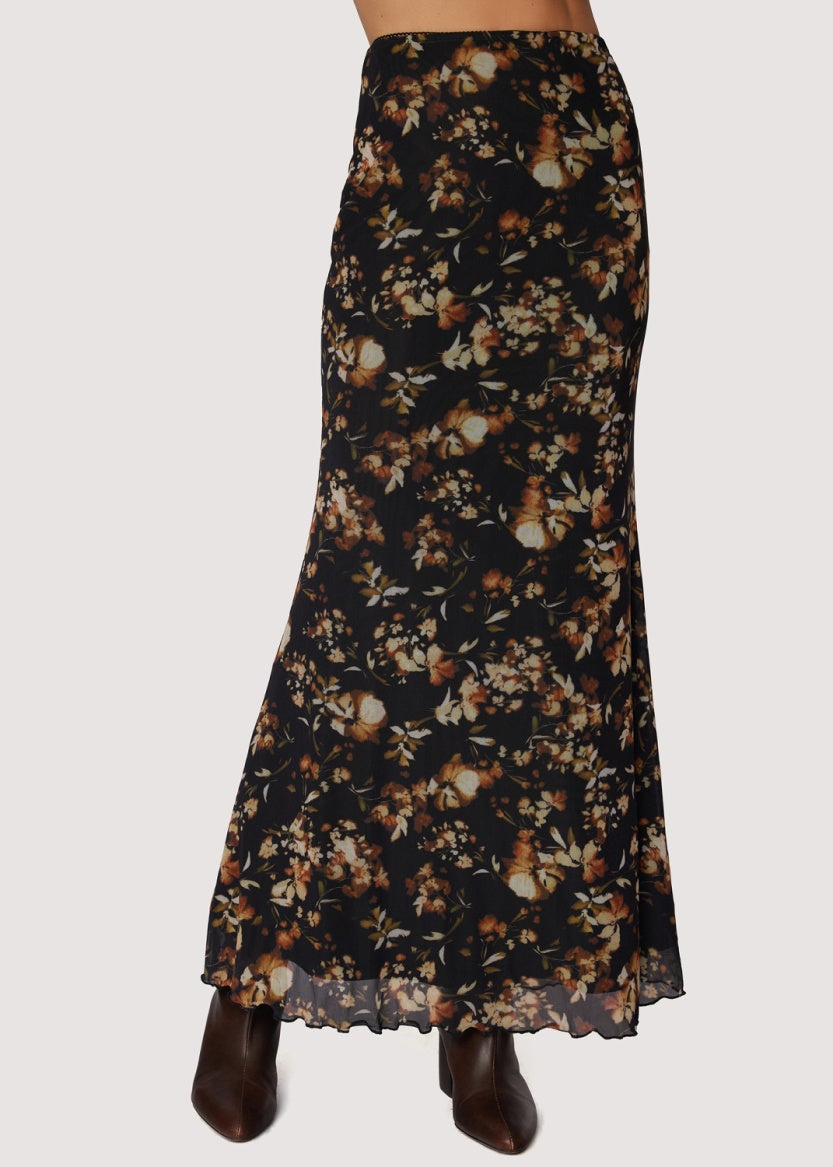 Long skirt black back ground with floral. earth tone pattern in rust , tan and gold