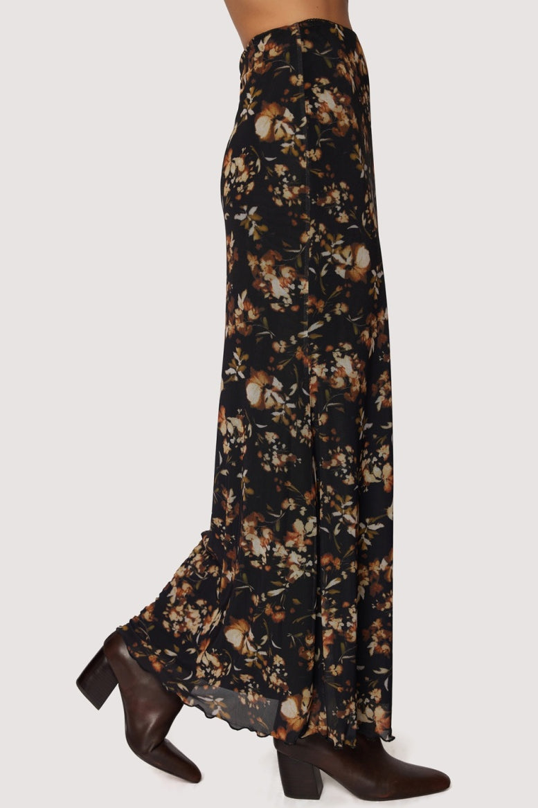 Floral patterned skirt with brown shoes on a white background