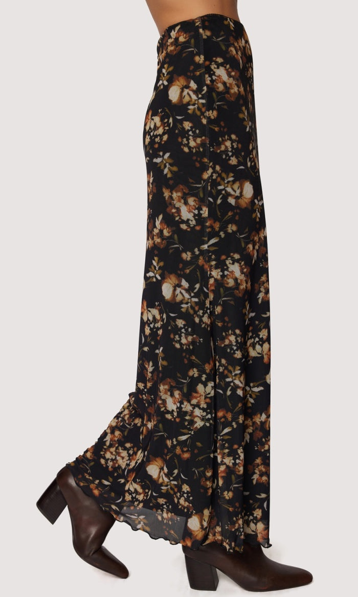 Floral patterned skirt with brown shoes on a white background