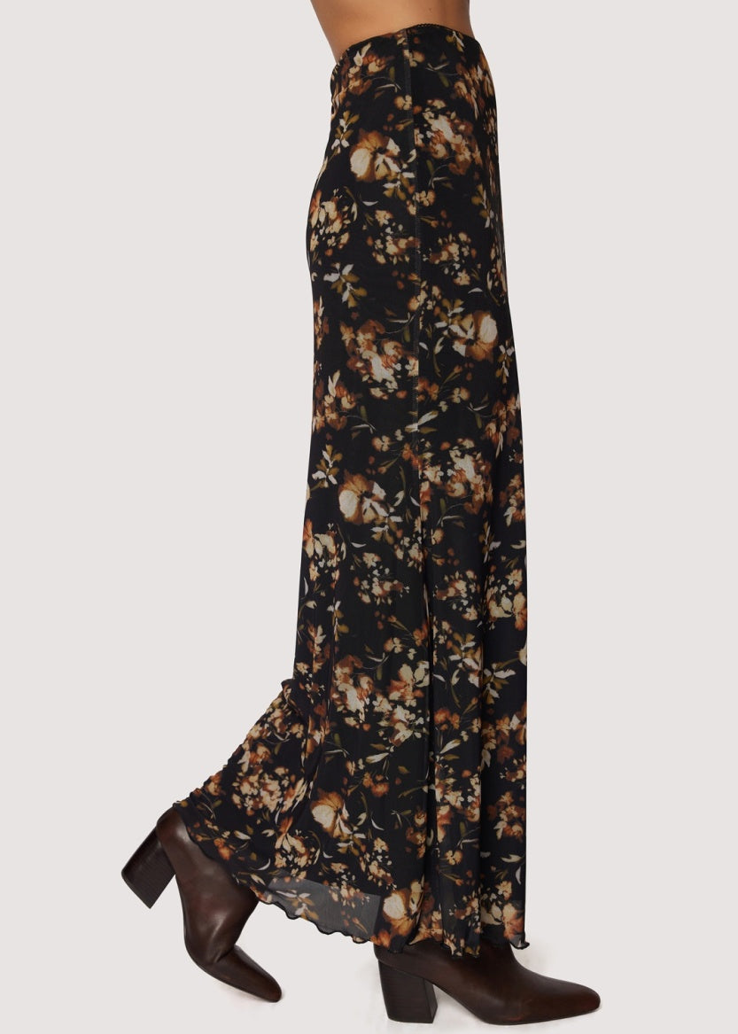 Floral patterned skirt with brown shoes on a white background