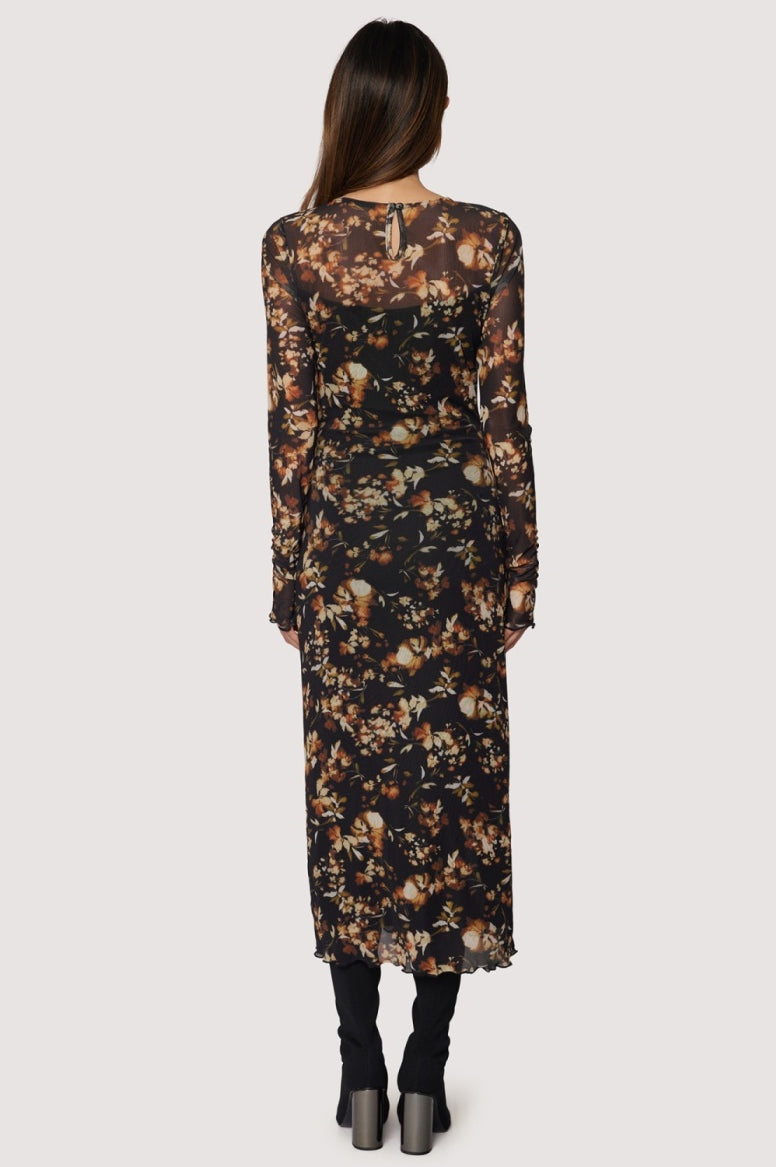 Woman wearing a floral dress with a neutral background