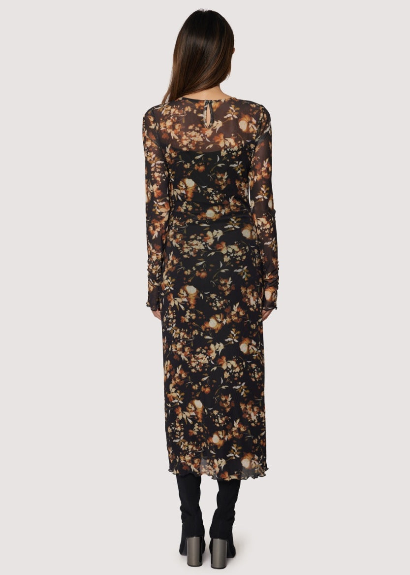 Woman wearing a floral dress with a neutral background