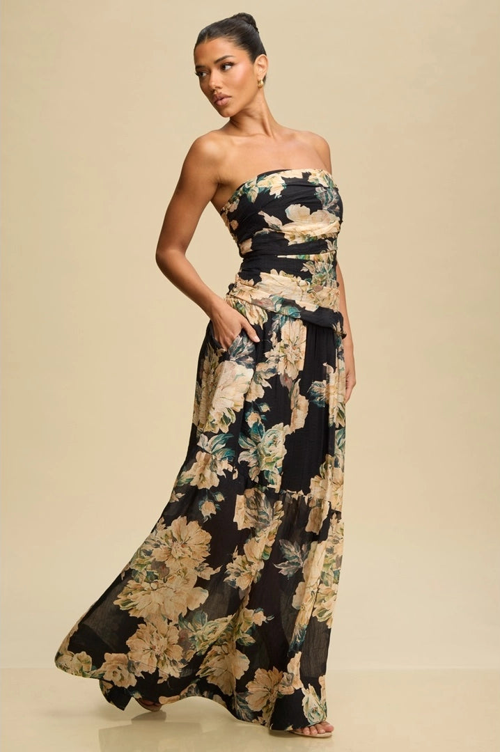 Woman wearing a strapless floral dress against a beige background