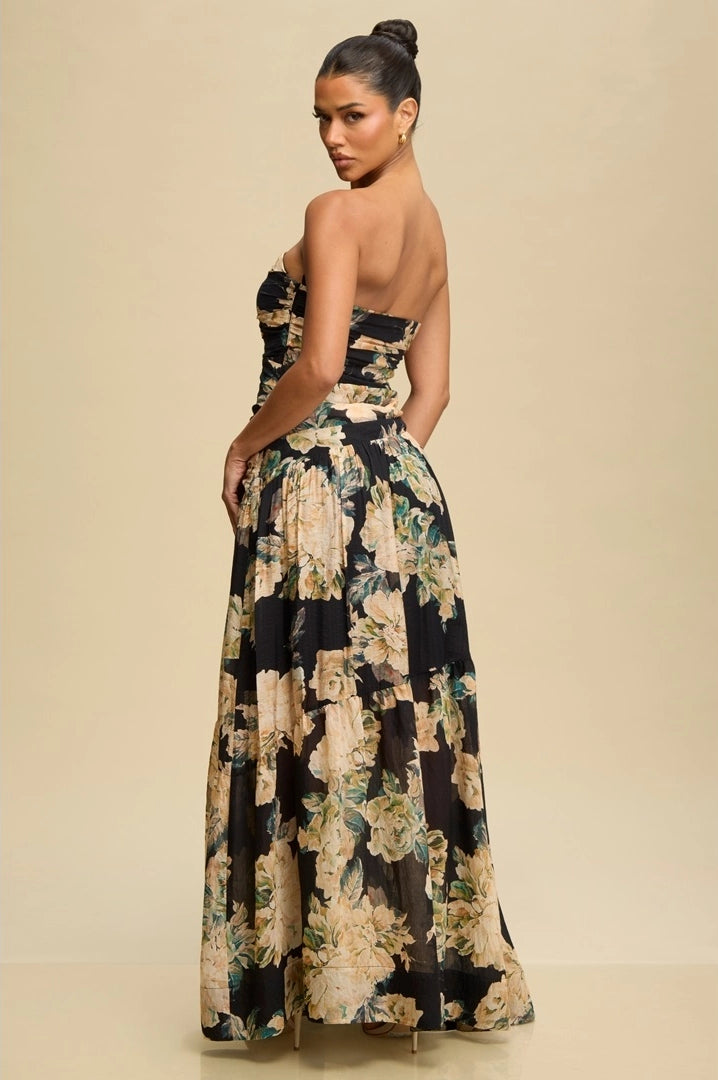 Woman wearing a floral strapless gown against a beige background
