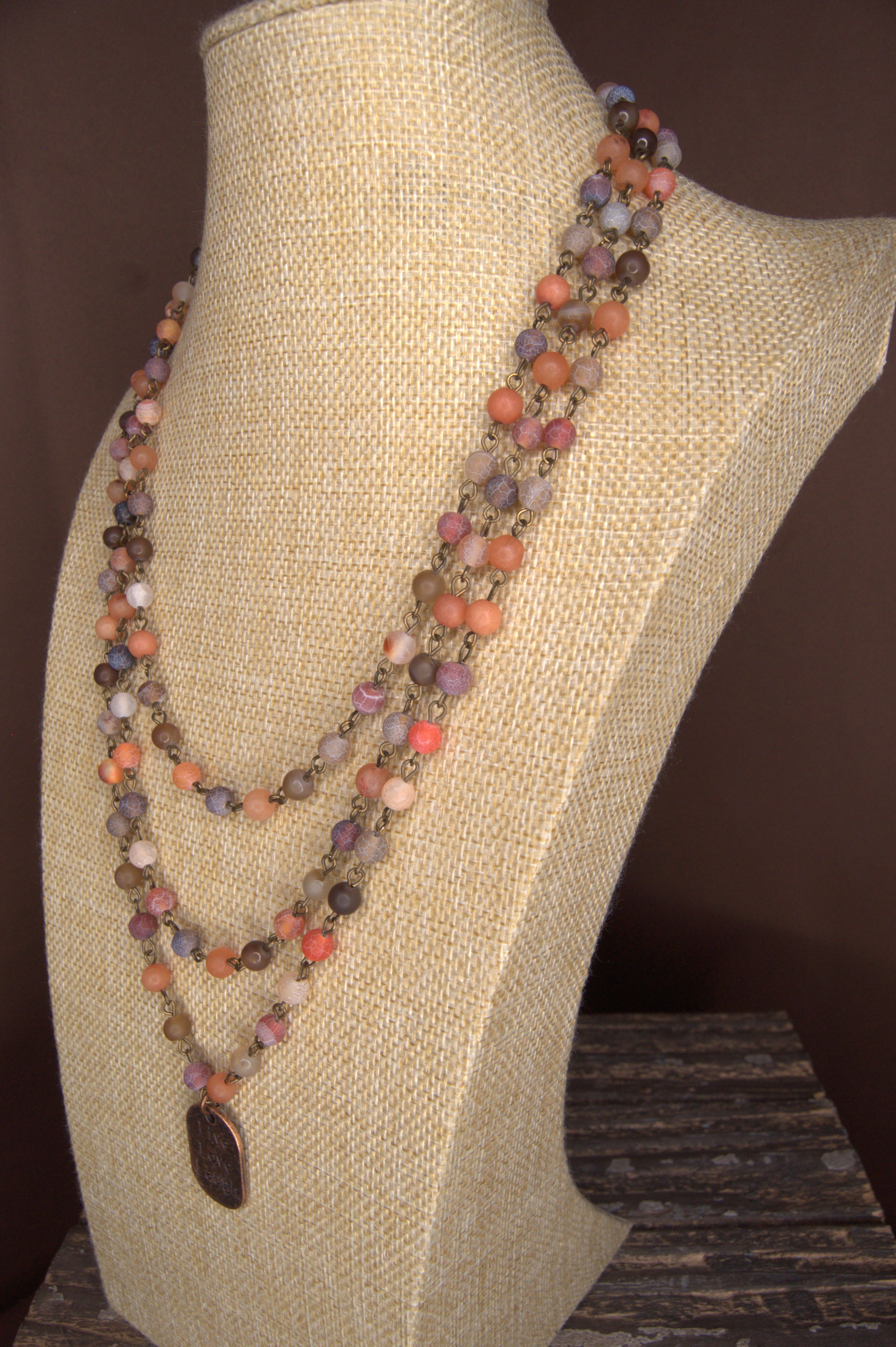bust with a 2 strand 6mm beaded necklace in 6mm Red Moss, Orange-Red Moss, and Brown Line Matte Agate beads with a copper tag stamped with Live Love Laugh