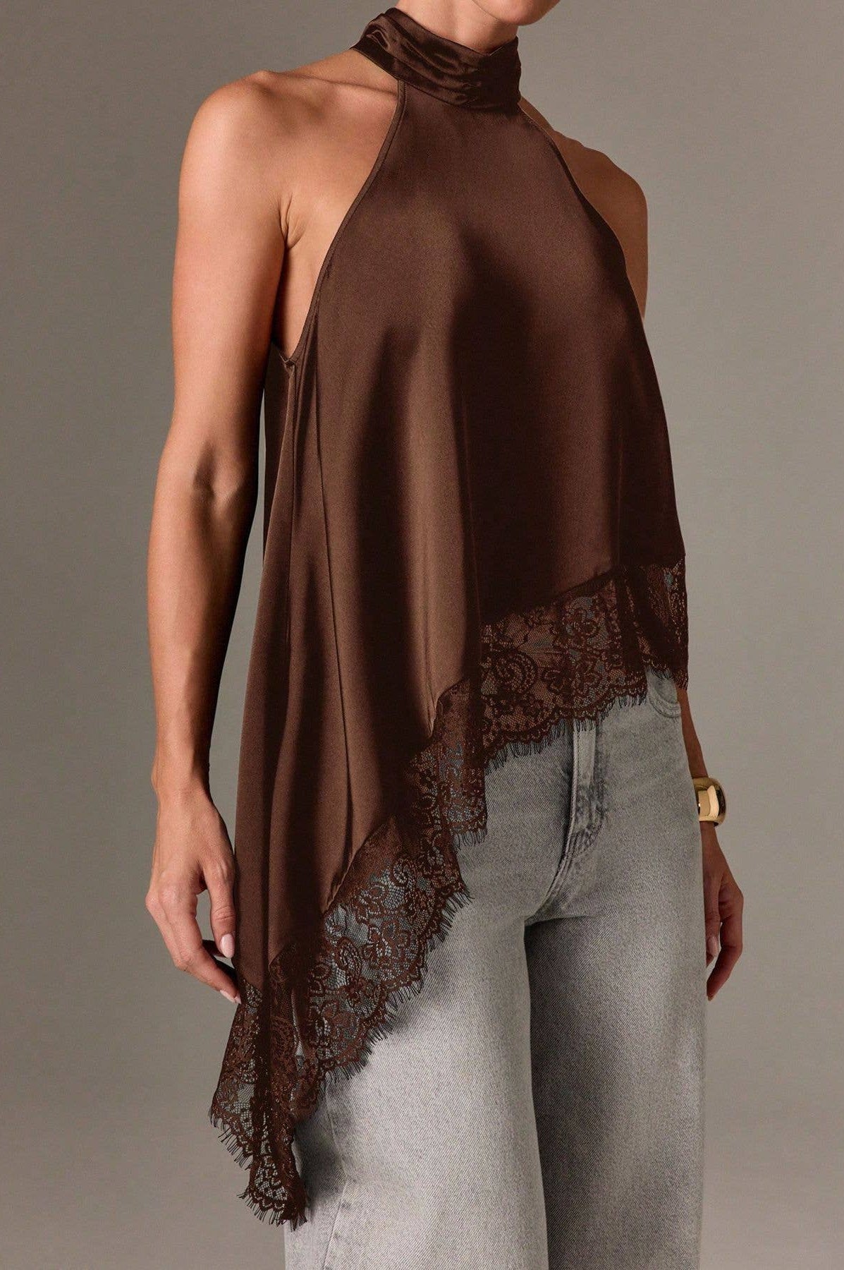Brown halter top with lace detail worn by a model on a plain background