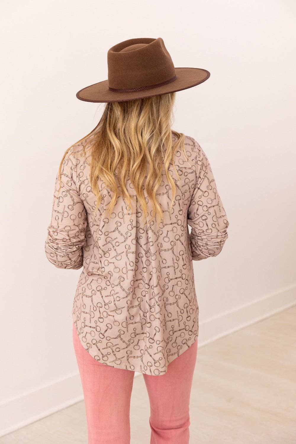 Back view of V-neck stretch top with roll-tab sleeves in a relaxed fit tan with brown horse bit pattern all over top