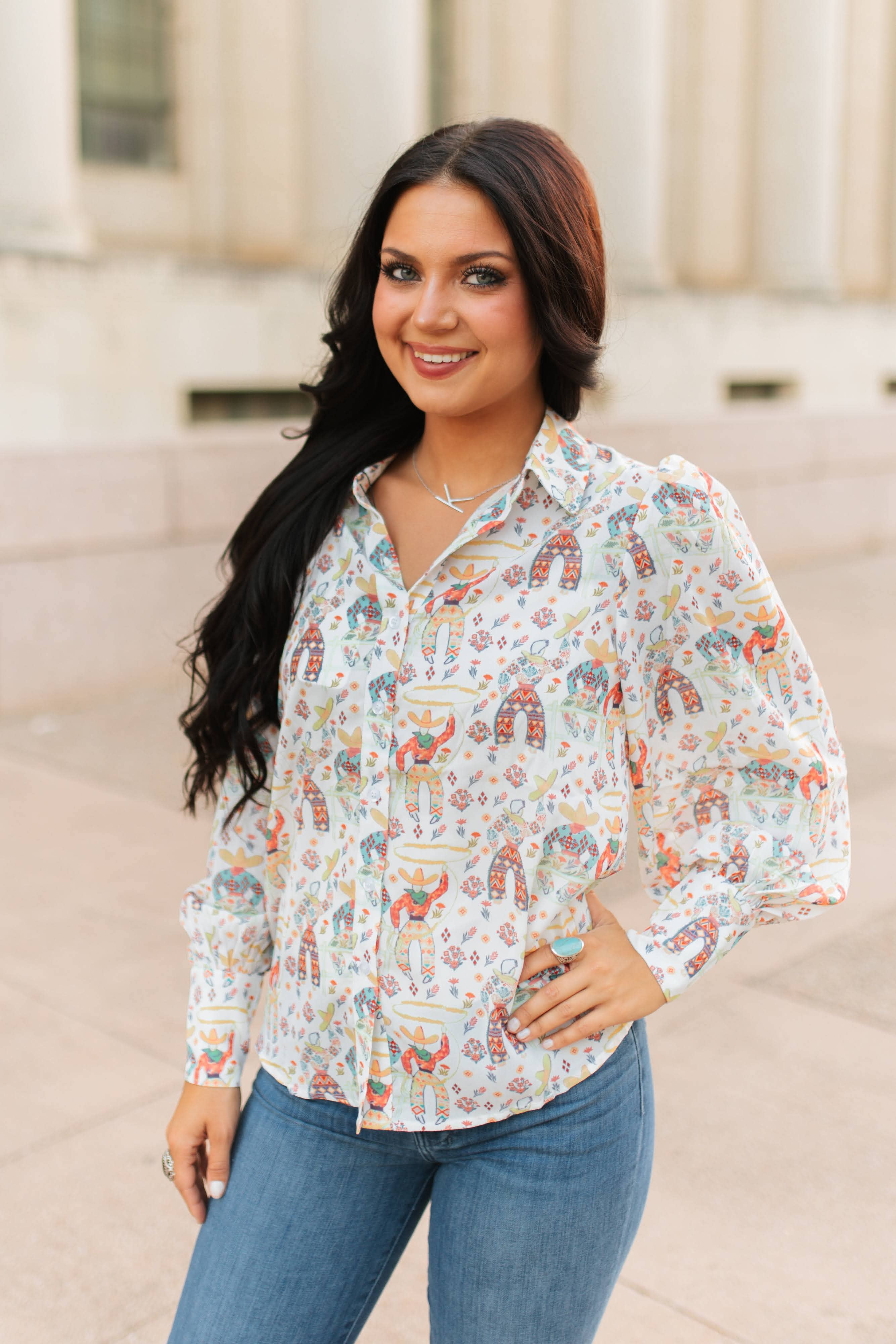 Woman wearing a patterned blouse with a neutral background