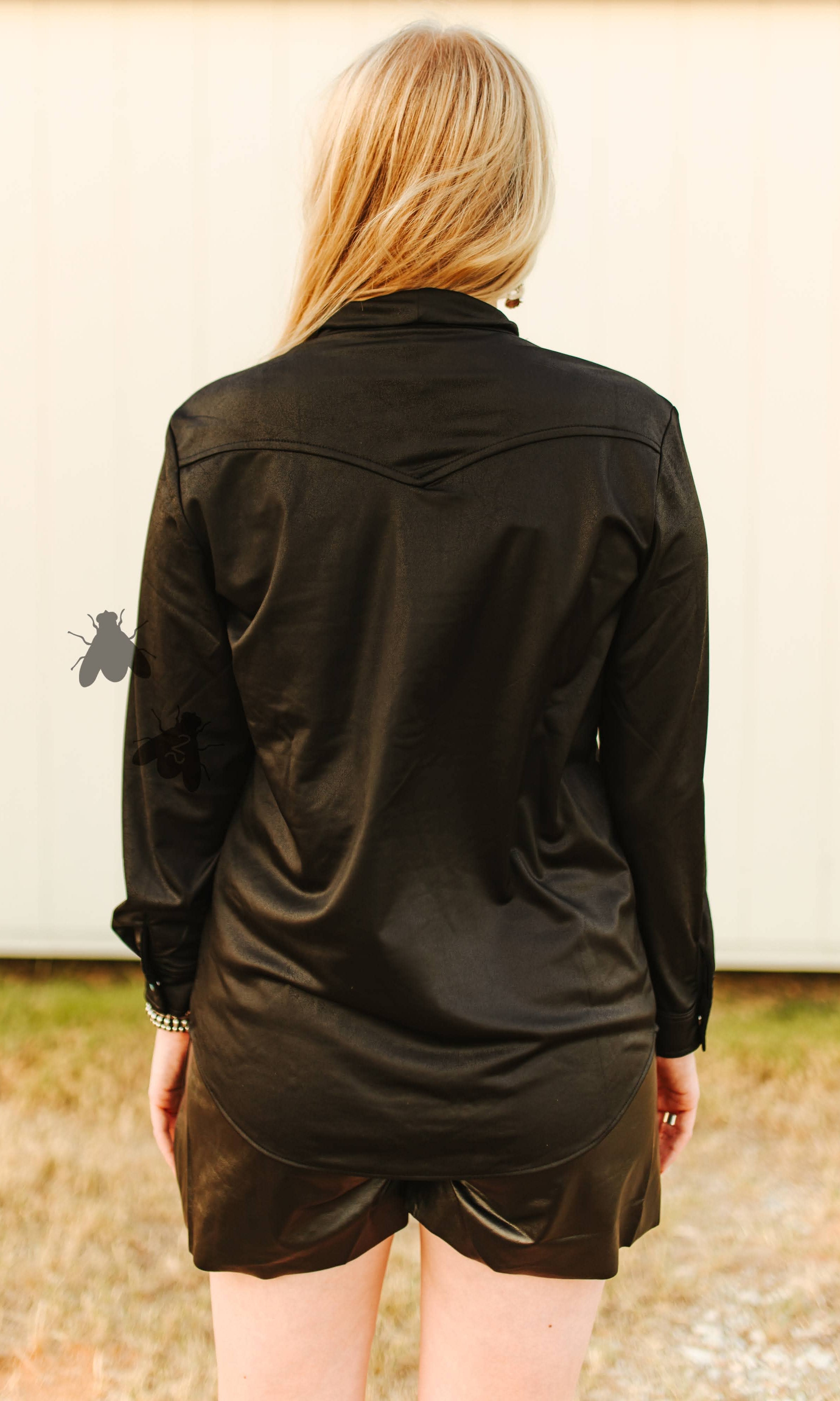 Person wearing a black shirt and shorts outdoors back view