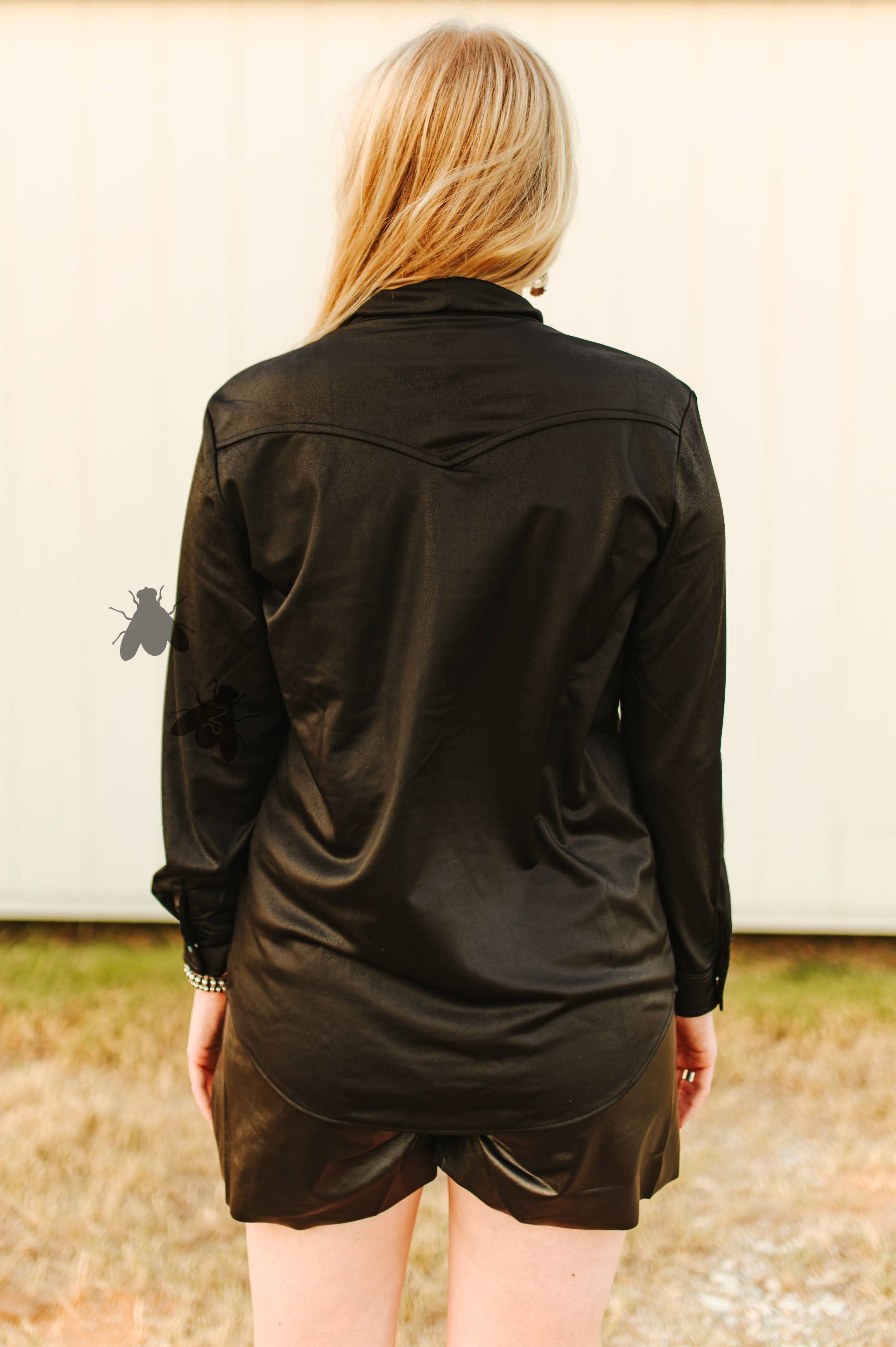 Person wearing a black shirt and shorts outdoors back view