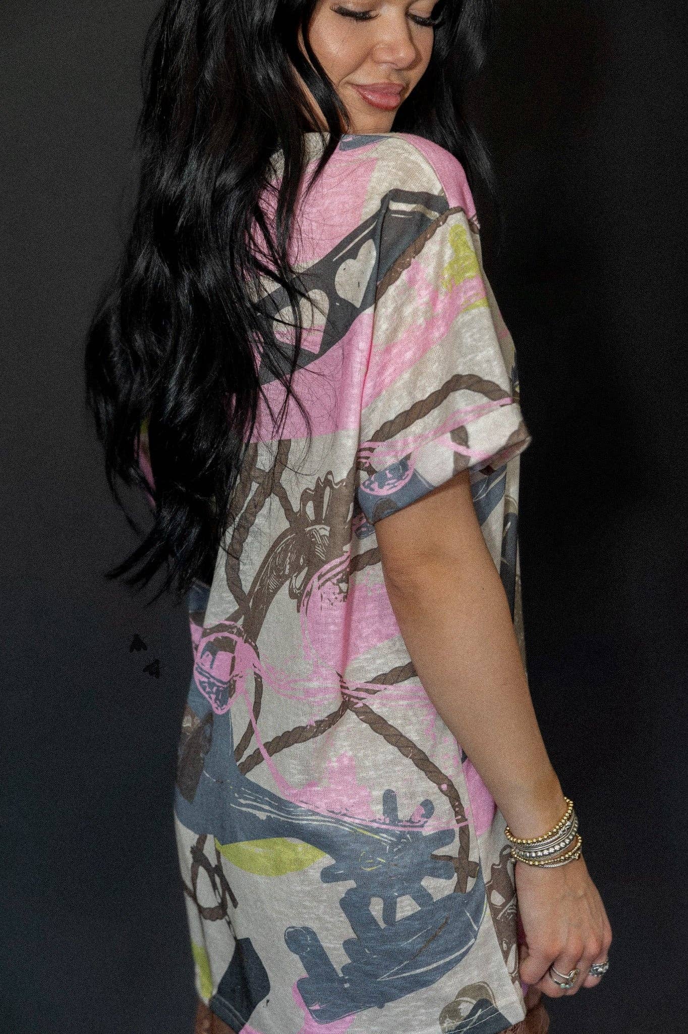 v-neck mom cuff tee with western spur-and-rope pattern, cuffed sleeves, subtle burnout texture.