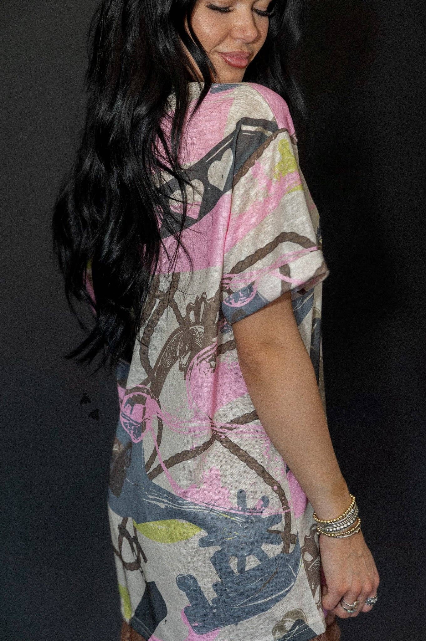 v-neck mom cuff tee with western spur-and-rope pattern, cuffed sleeves, subtle burnout texture.