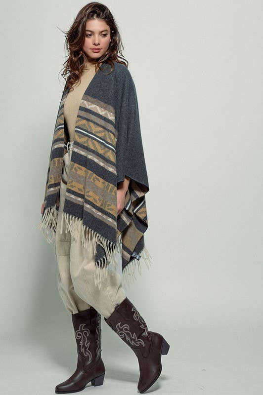Dark gray poncho with brown and beige striped pattern and fringes on a white background