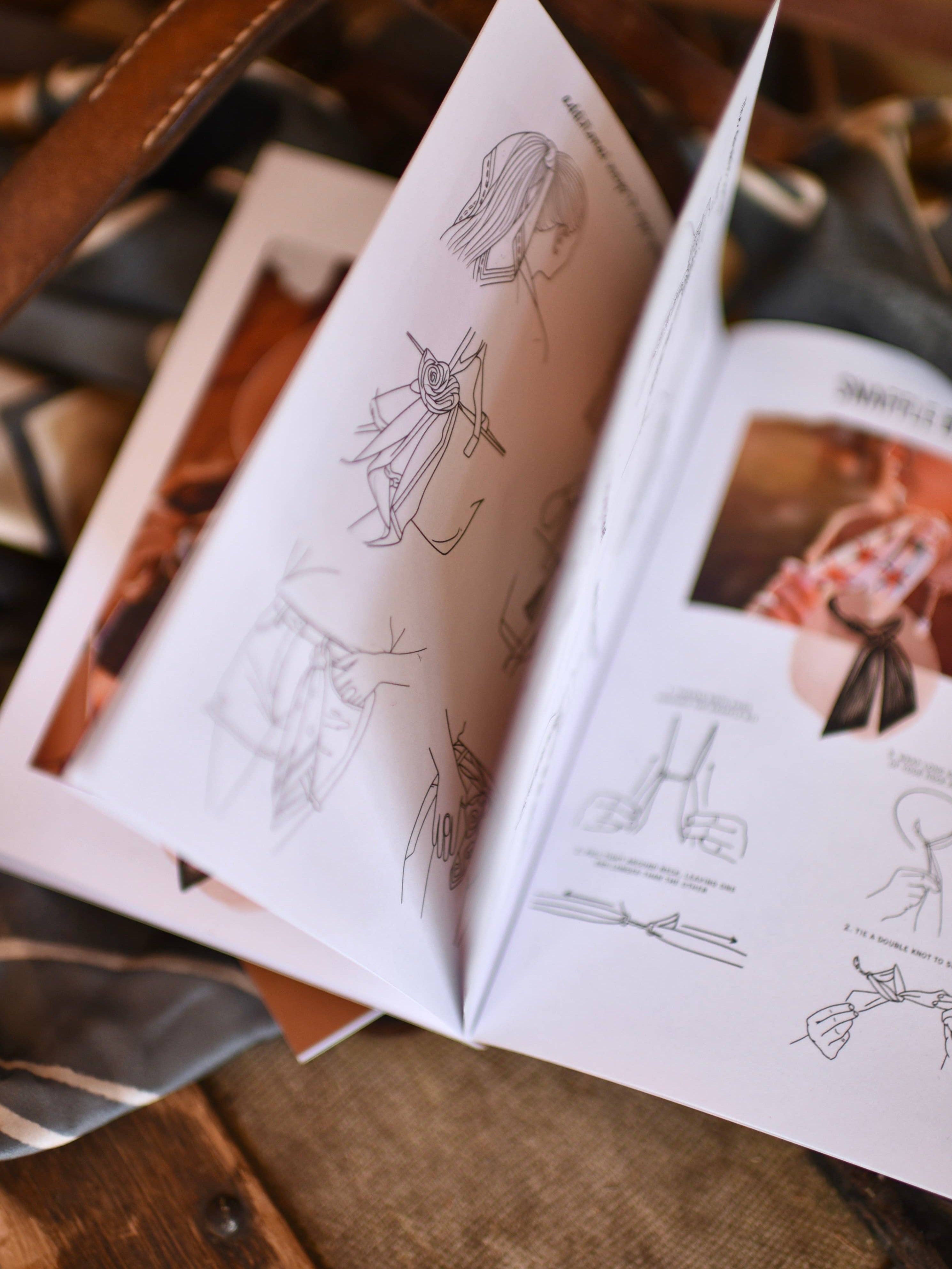 Open book with illustrations on a wooden surface