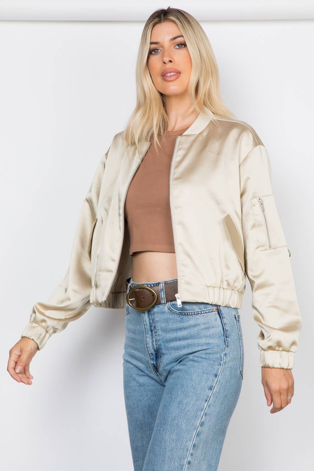 Lightweight satin bomber jacket featuring a relaxed fit, full front zipper, elastic cuffs, fully lined construction, utility sleeve pocket, and side pockets for polished everyday layering.