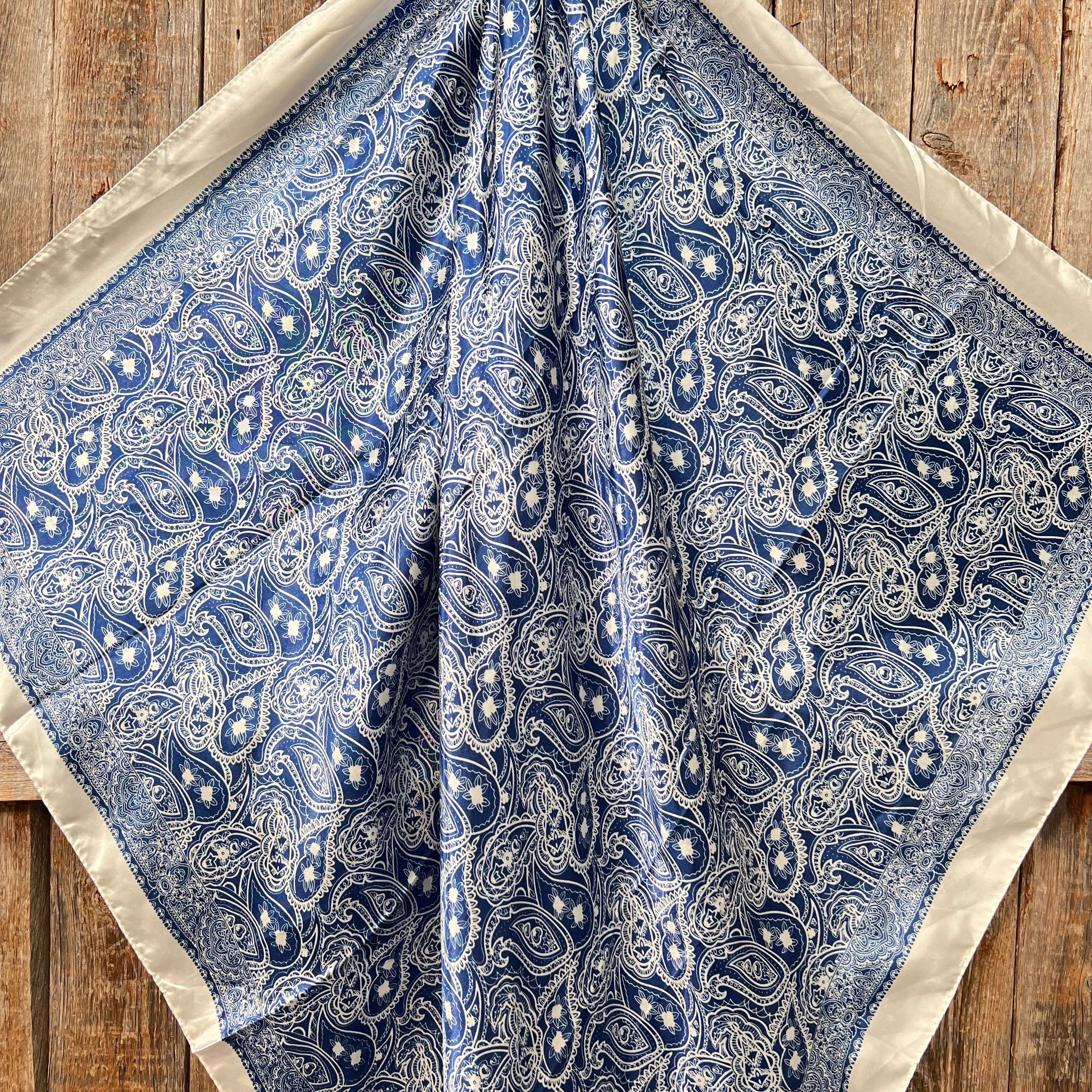 Blue paisley patterned fabric on a wooden surface
