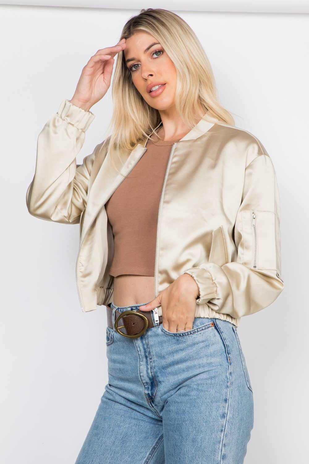 Lightweight satin bomber jacket featuring a relaxed fit, full front zipper, elastic cuffs, fully lined construction, utility sleeve pocket, and side pockets for polished everyday layering.